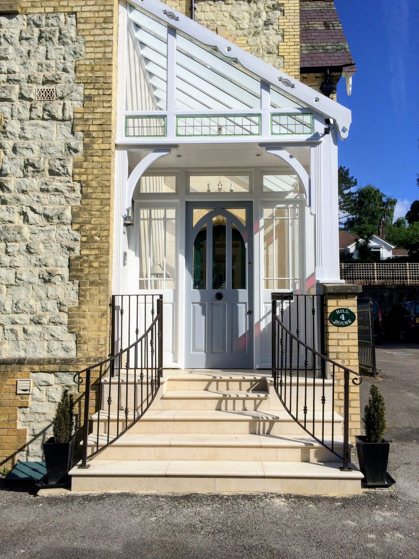 Front door and entrance porch with custom handrails and flagstone stairs