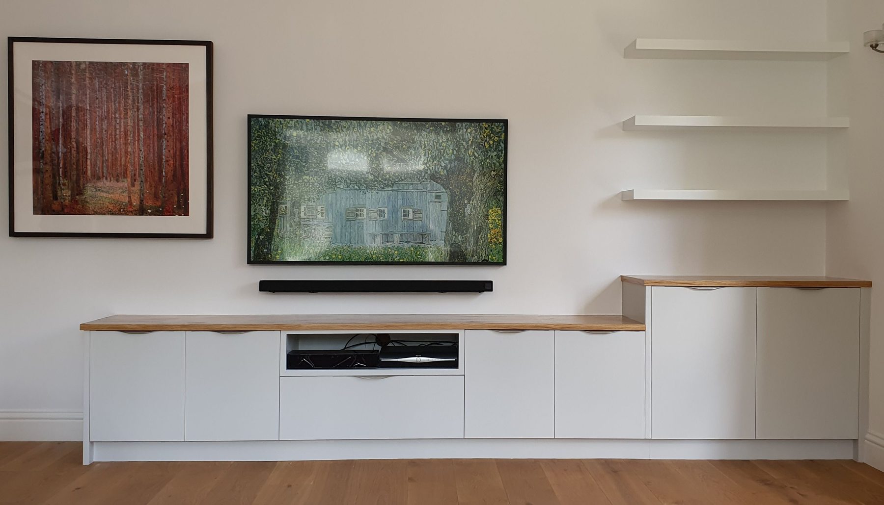 Fitted media wall with shelving and cabinetry
